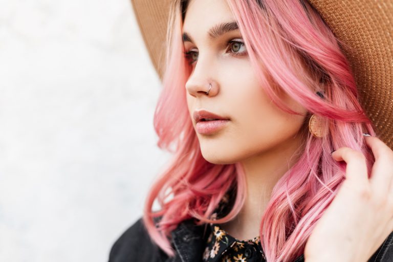 Portrait beautiful European young woman with gorgeous pink hair